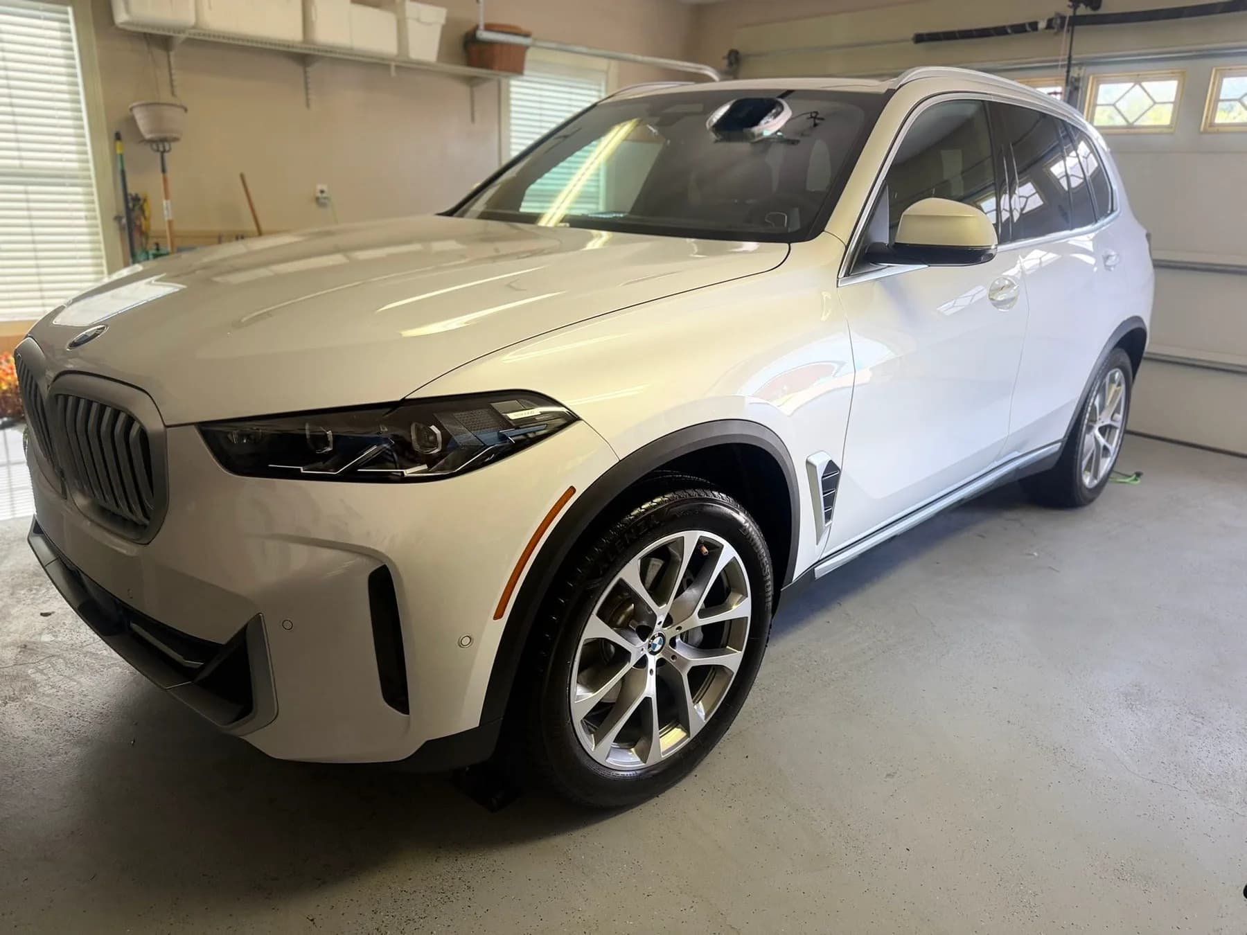 Detailed white BMW SUV in a garage