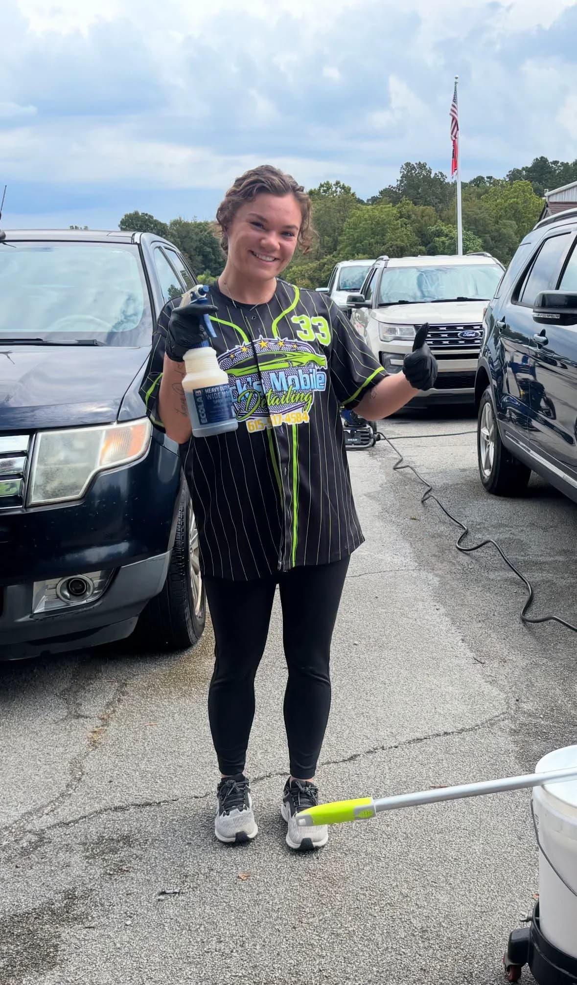 Maleah standing beside a vehicle